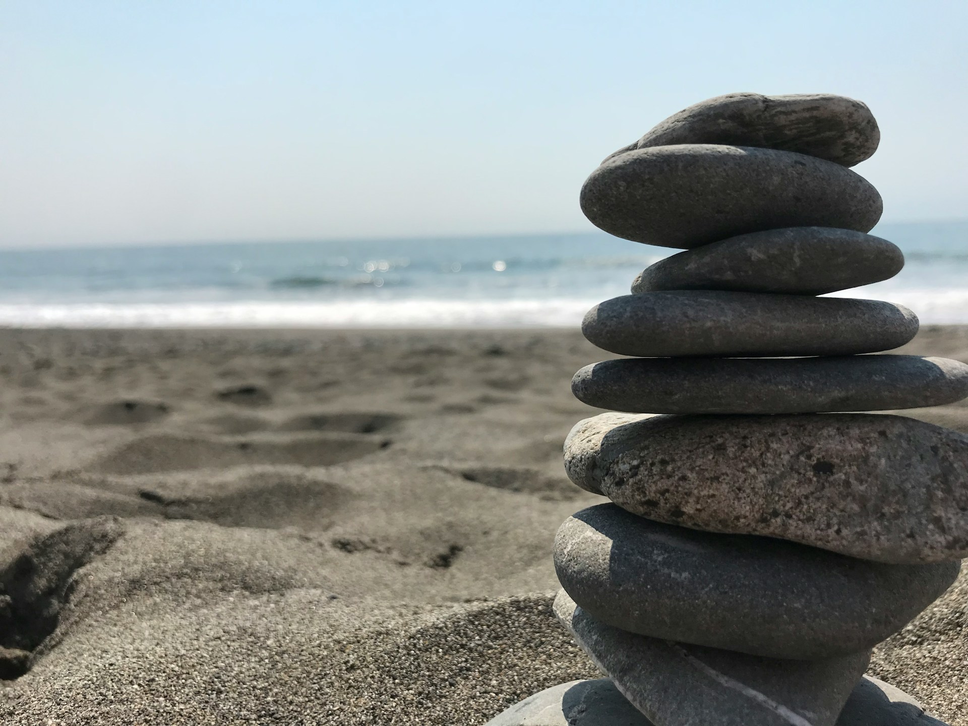 Stack of stones on beach during daytime